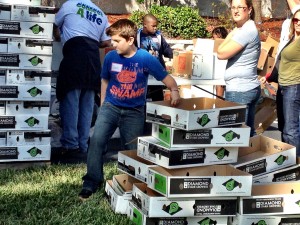 Brooks moves boxes in his University of Florida "swamp" shirt.